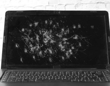 broken laptop screen on table close up .