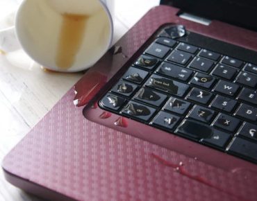 coffee spilling on laptop keyboard. close up